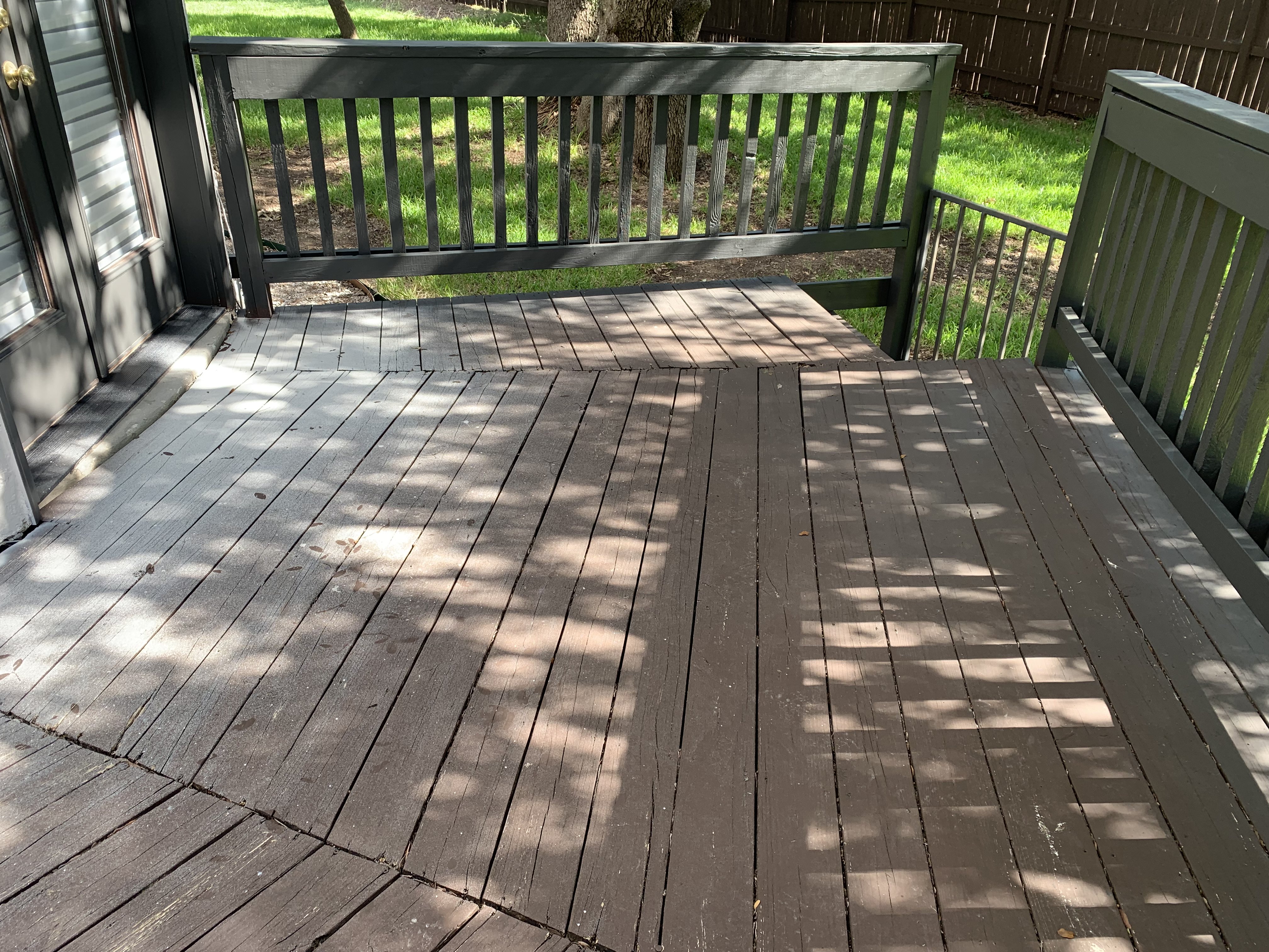 Weathered Boerne deck before cleaning — bare gray wood, worn boards, and old failing paint in spots