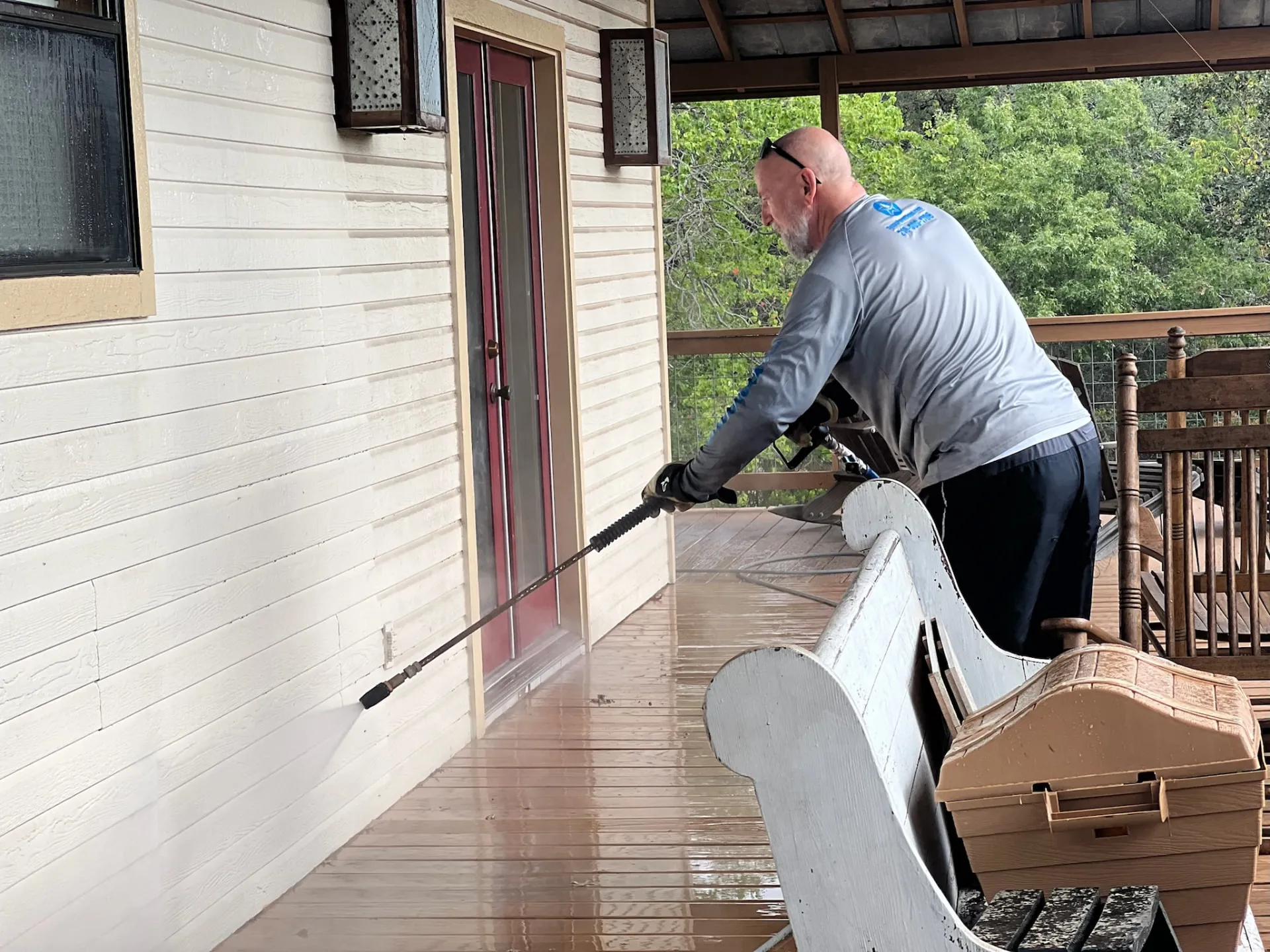 Texas Pure Clean technician soft washing a Helotes home exterior