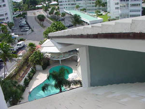Looking down from the seven-story roof onto the interior courtyard, pool deck, and landscaping.