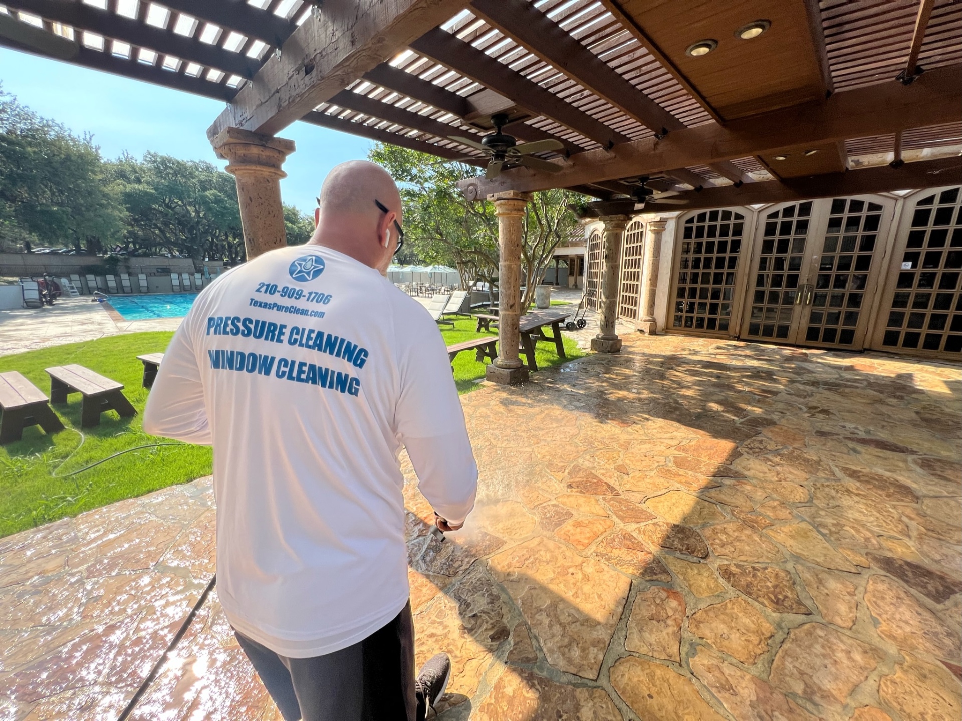 Soft washing the flagstone patio under the clubhouse pergola at the Dominion Country Club.