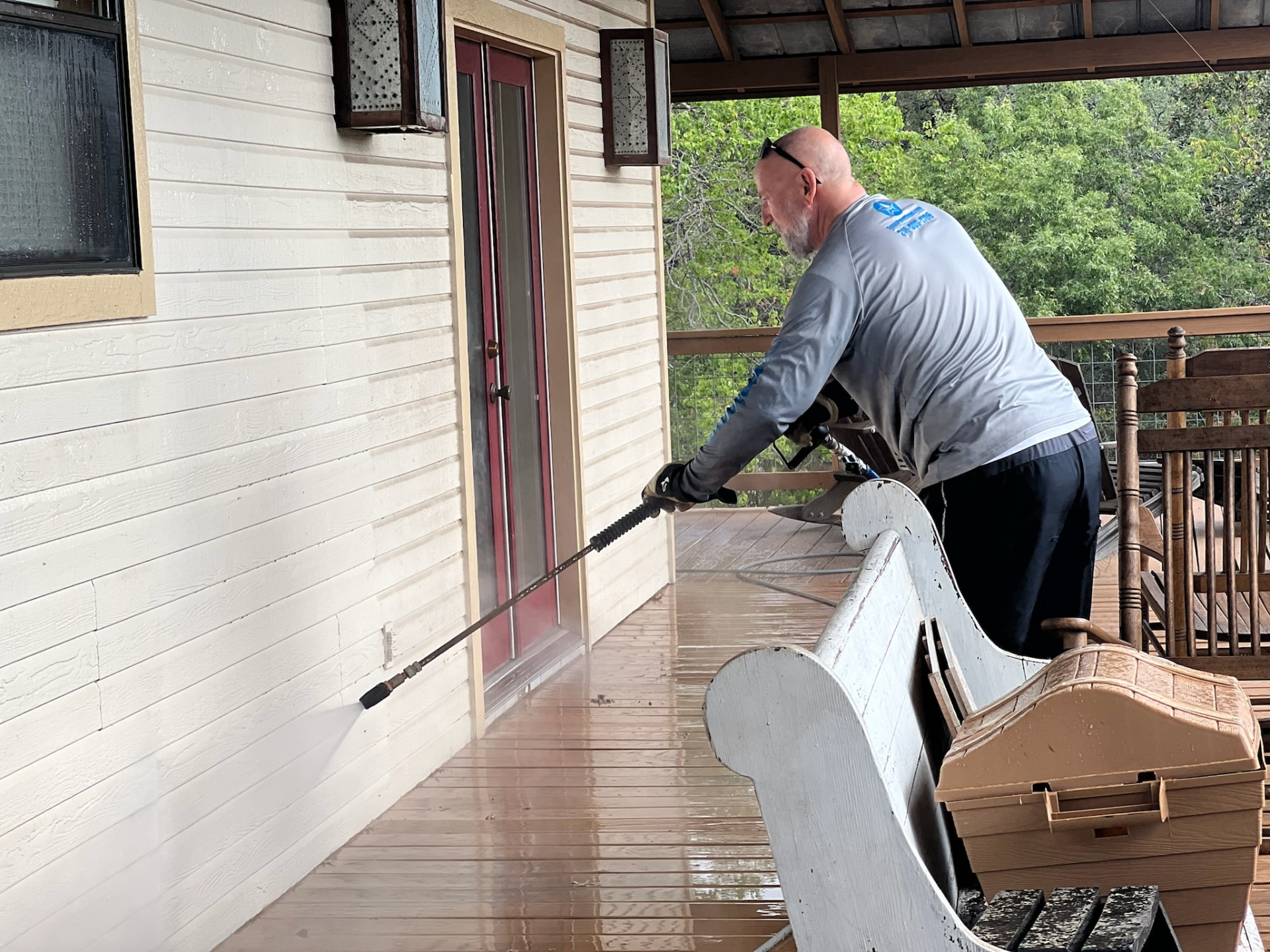 Texas Pure Clean technician soft washing a Helotes home exterior
