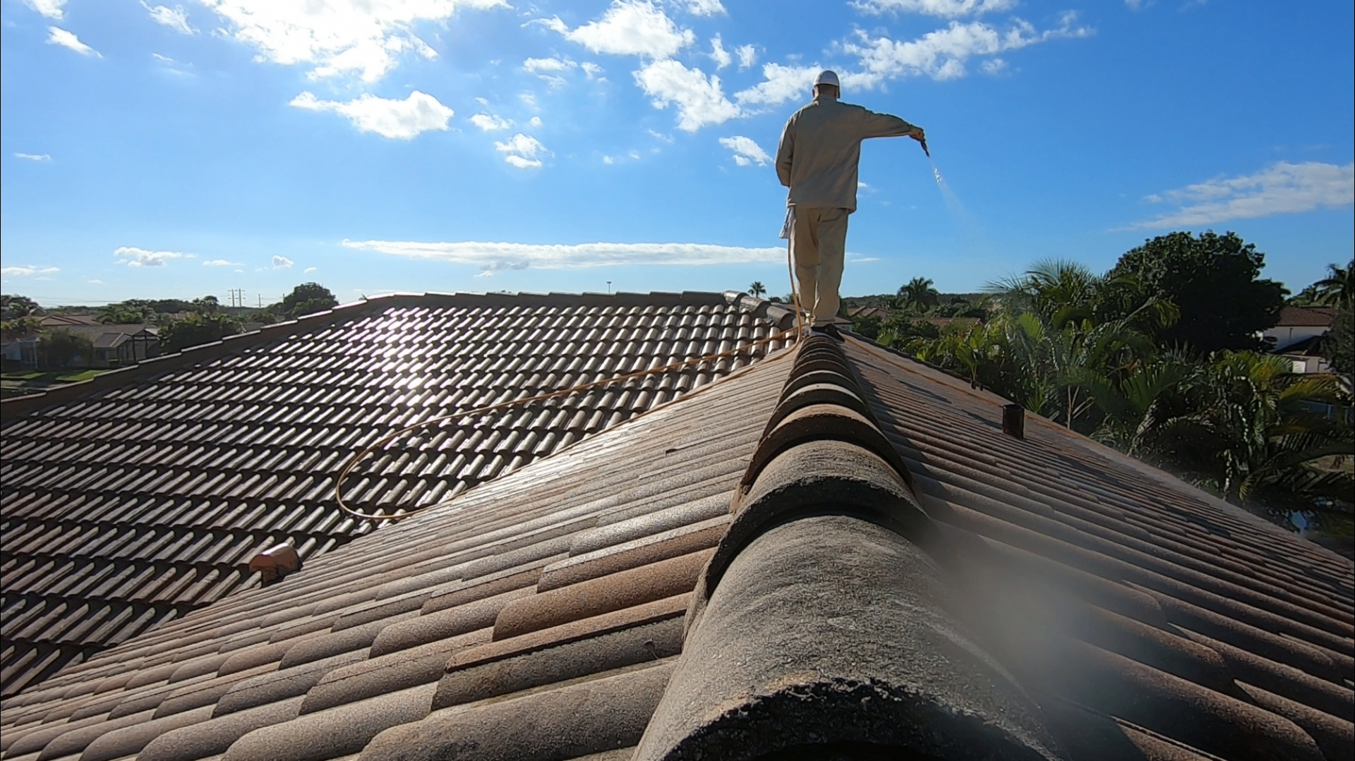 Bill of Texas Pure Clean applying soft wash treatment on a tile roof