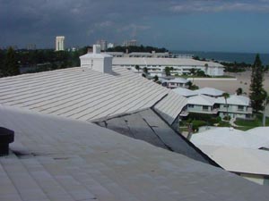 The finished roof — long, steep runs of standing-seam metal cleaned uniformly across the entire building.