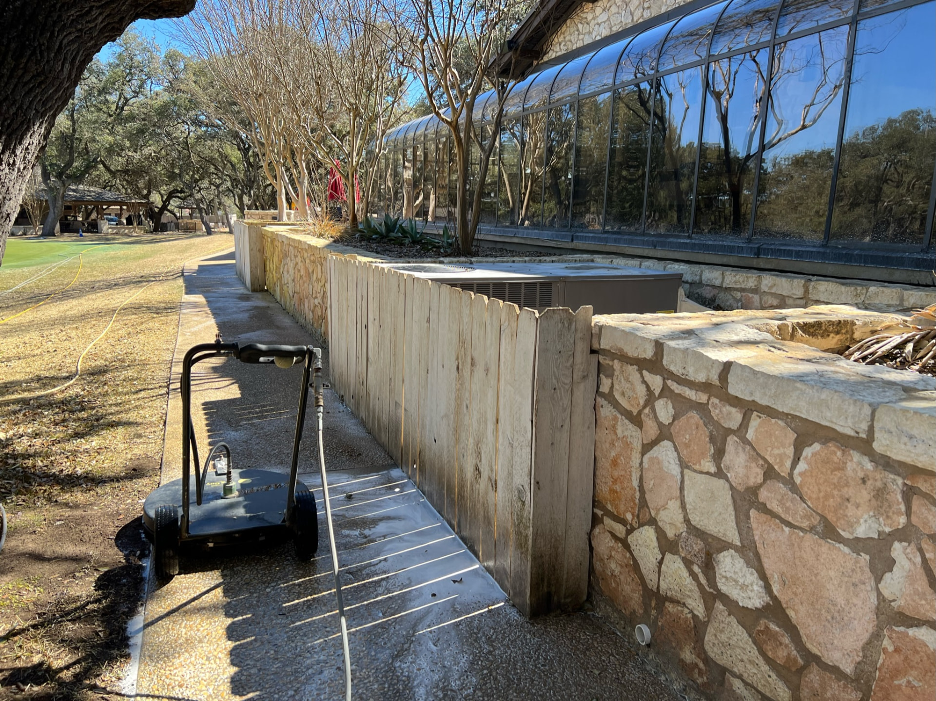 Texas Pure Clean surface cleaner restoring a Boerne commercial stone and wood walkway