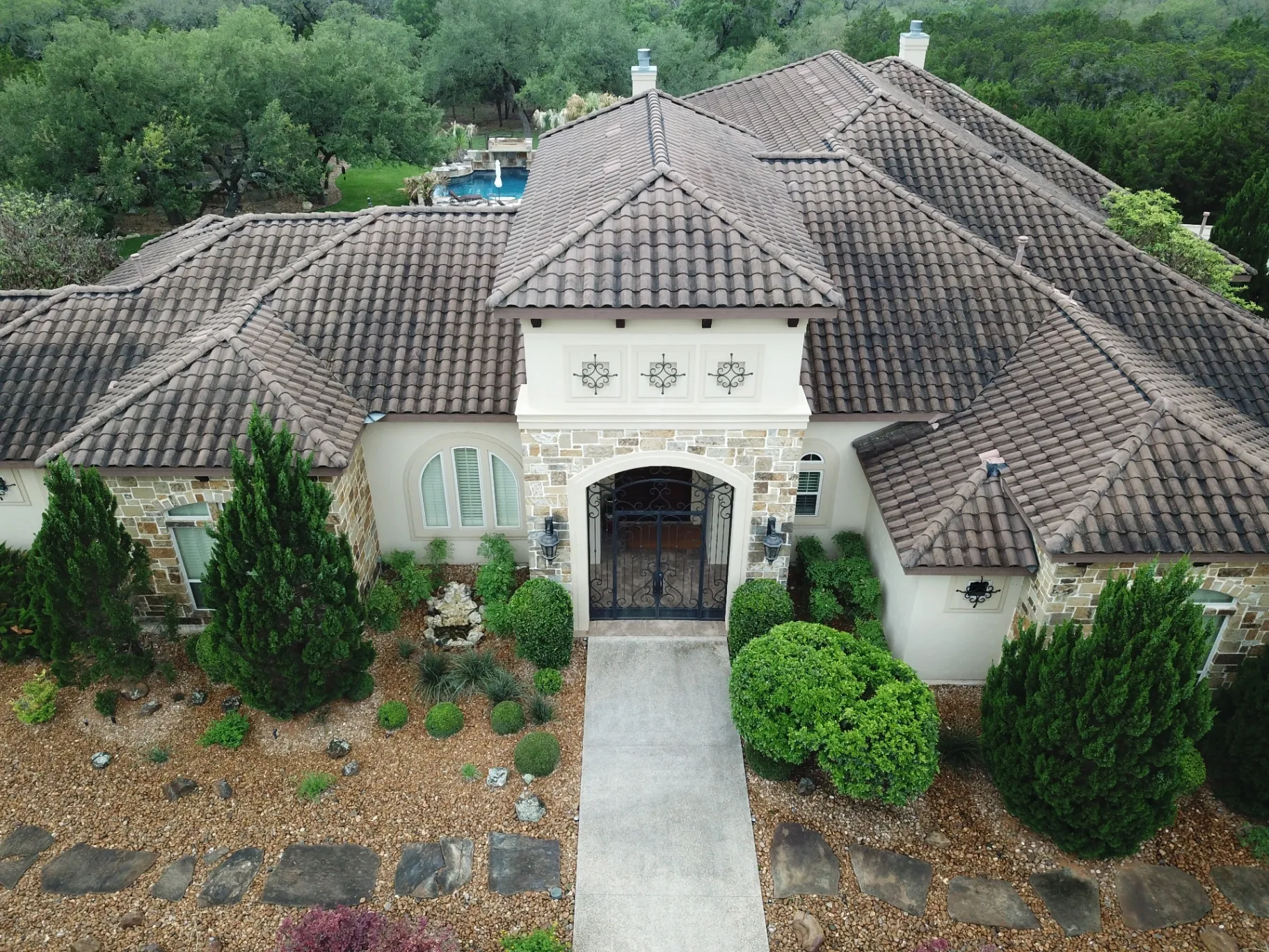 Tile roof with dark staining before soft wash cleaning