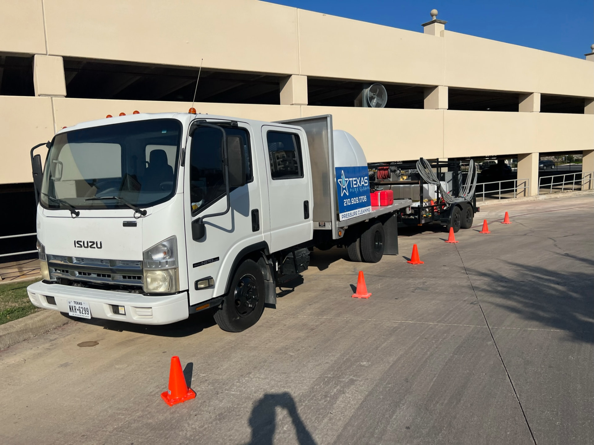 Texas Pure Clean commercial pressure washing truck and rig at a San Antonio parking garage