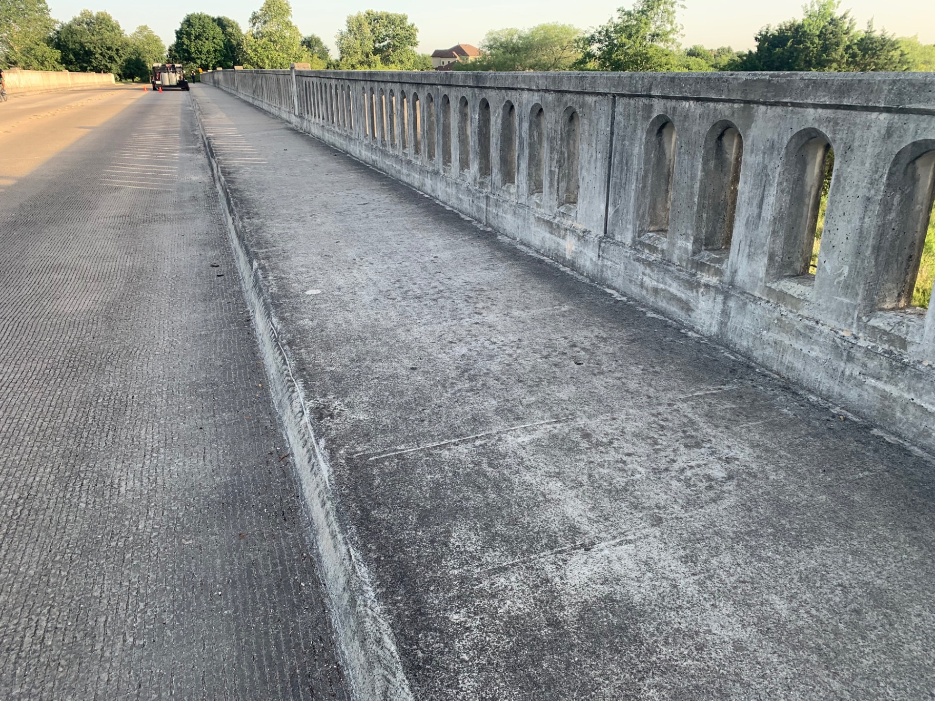 Deer Meadow Estates bridge in Fair Oaks Ranch before cleaning, with heavy algae staining and grime on the concrete railing and walkway