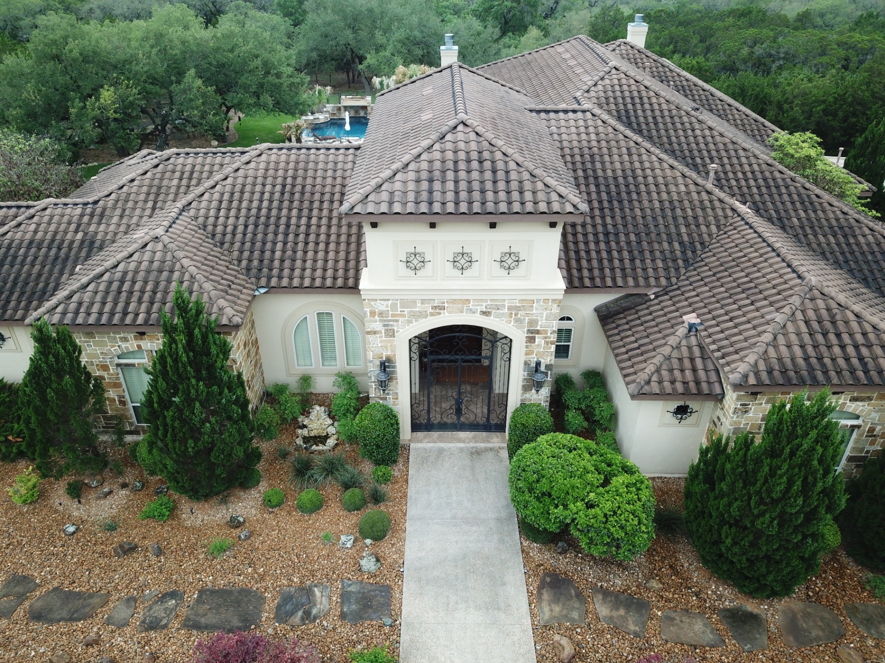 Tile roof with dark staining before soft wash cleaning