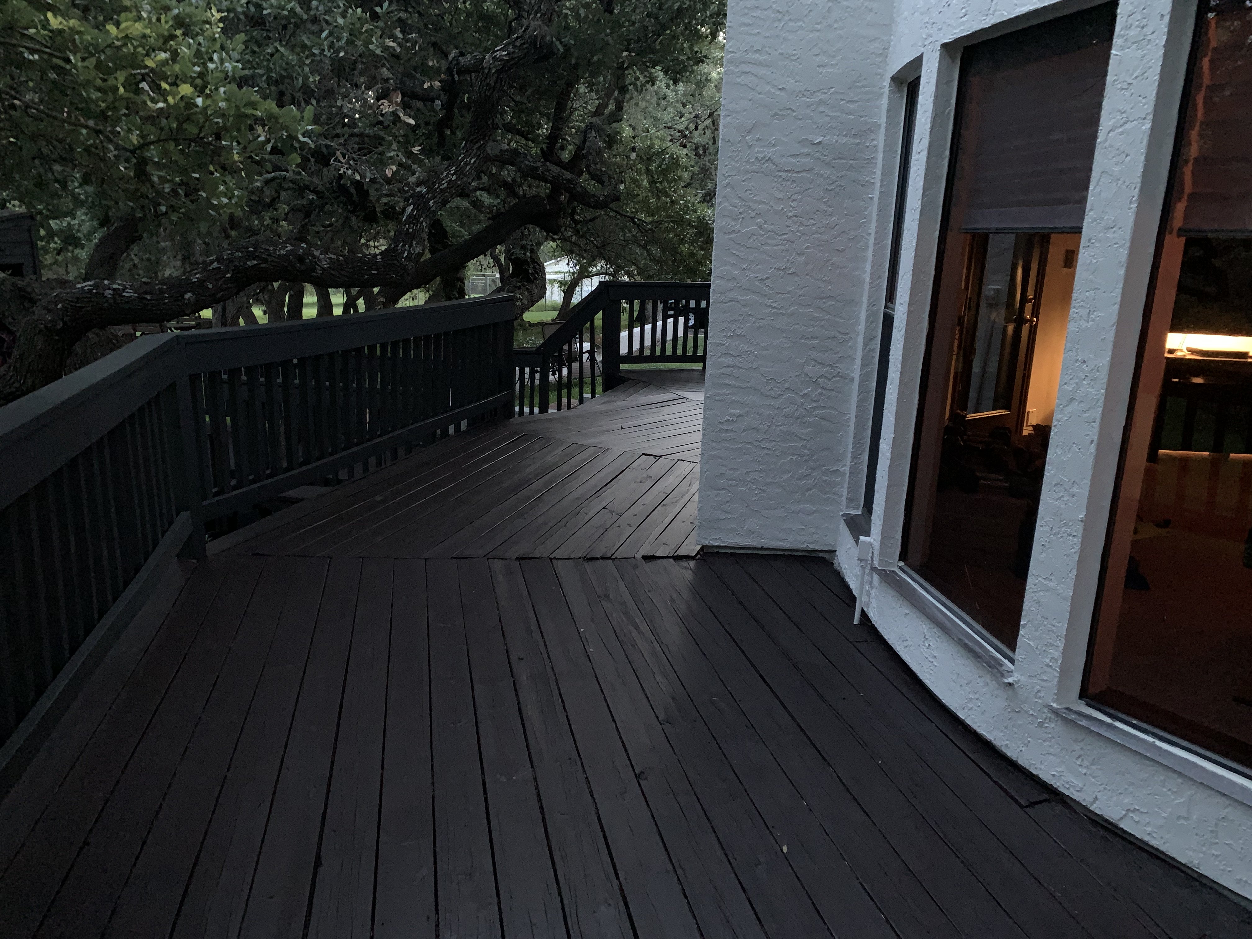 Close-up of the finished deck boards after cleaning and staining — smooth surface, sealed grain, and a rich, even tone
